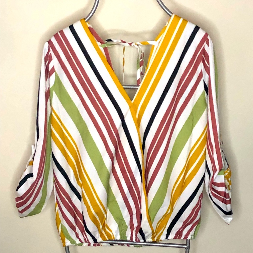 Striped top. 3/4 button sleeves. Tie back. V-neck front and back. Elastic bottom